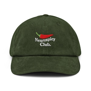 May include: A dark green corduroy baseball cap with a curved brim. The cap features an embroidered design of a red chili pepper with a green stem above the words "Neurospicy Club" in white.