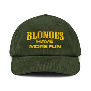 May include: A dark green corduroy baseball cap with the text "BLONDES HAVE MORE FUN" embroidered in yellow. The cap has a curved peak and an adjustable strap at the back.