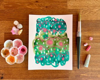Könnte beinhalten: Abstrakte Aquarellmalerei in Türkis und Rosa auf weißem Papier. Eine runde Farbpalette mit verschiedenen Farben, ein Pinsel und Künstlerbedarf sind auf einer Holzoberfläche angeordnet.