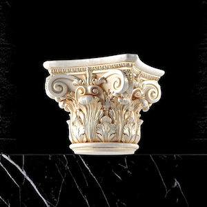 May include: A detailed, off-white Corinthian column capital with gold accents. The capital features intricate carvings of acanthus leaves and scrollwork. The design is set against a black background, highlighting the architectural details.