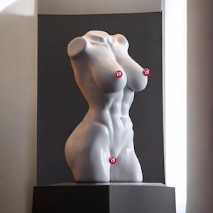 May include: A white, glossy sculpture of a female torso, with defined abdominal muscles and breasts. The sculpture has three small, circular stickers with the number "18" on it. It is displayed on a black pedestal against a grey background.