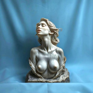 May include: A marble bust sculpture depicting a person with wavy hair, head tilted back, and eyes closed. The figure has a smooth, pale finish with subtle grey veining throughout the stone, resting on a textured, block-like base of matching marble.