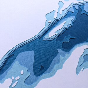 May include: Abstract paper art with layered blue shapes, creating a 3D effect. The shapes resemble a wave or a mountain range.