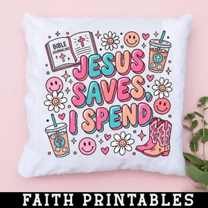 May include: White square pillow with a colorful graphic design. The design includes the text "JESUS SAVES, I SPEND" in bubble letters, along with illustrations of a Bible, smiley faces, flowers, and cowboy boots.