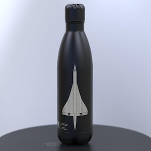 May include: Black insulated water bottle with a white illustration of a Concorde supersonic jet. The bottle has a matte finish and a black screw-on cap. The design includes text at the bottom of the bottle.