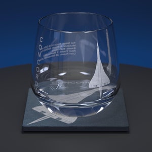 May include: A clear glass tumbler with an etched design of the Concorde supersonic jet. The glass is sitting on a dark grey coaster with the word "CONCORDE" etched on it.