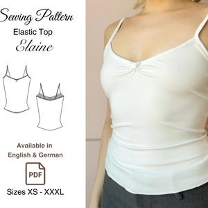 Op de afbeelding: Een naaipatroon voor een elastisch topje genaamd "Elaine". Het patroon is beschikbaar in het Engels en Duits en omvat maten XS tot XXXL. Het patroon is afgebeeld op een wit tanktop met een geplooide detail aan de halslijn.