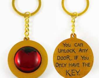Red and Gold Sparkly Keychain With Inscription - Secret of NIMH Amulet