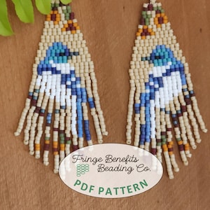 May include: A pair of beaded earrings with a fringe design. The earrings are made with beige, blue, white, brown, and orange beads. The earrings are hanging from silver hooks. The image also includes the text "Fringe Benefits Beading Co. PDF PATTERN".