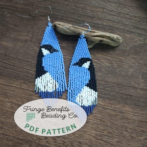 May include: Blue beaded earrings with a bird design. The earrings feature a blue background with black and white bird details. The earrings are triangular in shape with a fringe at the bottom. The text "Fringe Benefits Beading Co. PDF PATTERN" is visible.