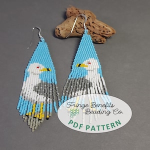May include: Handmade beaded earrings featuring a seagull design. The earrings have a blue, white, gray, and yellow color scheme. The earrings are made with small beads and have a fringe at the bottom. The earrings are a PDF pattern.