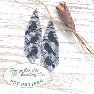 May include: A pair of long, teardrop-shaped earrings crafted from small, light grey and dark charcoal beads arranged in a geometric pattern with a fringed bottom edge. An oval label at the bottom reads Fringe Benefits Beading Co. PDF PATTERN.