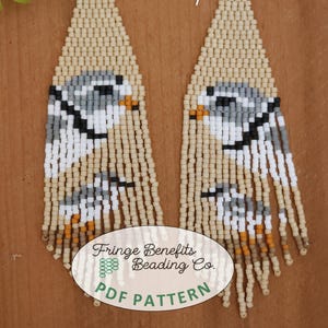 May include: Beaded earrings with a fringe design featuring a small bird in shades of gray, white, and black. The earrings are beige and have brown, orange, and white accents. The image includes the text "Fringe Benefits Beading Co. PDF PATTERN".