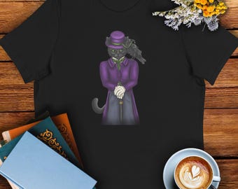 May include: Black t-shirt featuring a dapper cat illustration. The cat is depicted in a purple coat and top hat, holding a cane, with a raven perched on its shoulder. The design has a whimsical, Victorian-era aesthetic.