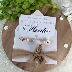 Mitteilung an die zukünftige Tante Schwangerschaft précentric Baby bébé Eltern Schwester Freund Überraschung Schlüsselbund beige fleur