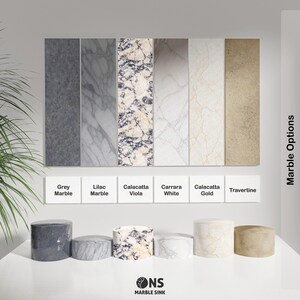 May include: Image displaying various marble options: Grey Marble, Lilac Marble, Calacatta Viola, Carrara White, Calacatta Gold, and Travertine. Rectangular samples and cylindrical pedestals of each marble type are shown. The text "Marble Options" is present.