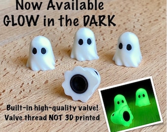 May include: Four white ghost-shaped valve caps with black eyes. Text reads: Now Available GLOW in the DARK. Built-in high-quality valve! Valve thread NOT 3D printed. An inset shows the ghost caps glowing green in the dark with black eye details.