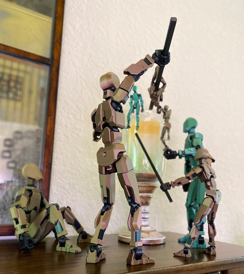 May include: Five articulated action figures, some with weapons, posed in a dynamic scene. The figures are made of plastic and have a metallic finish in shades of brown, green, and silver. The figures are standing on a wooden surface.