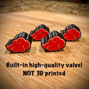 May include: Four black and red cloud-shaped accessories with a unique design. The accessories are arranged on a wooden surface. The text "Built-in high-quality valve! NOT 3D printed" is visible.