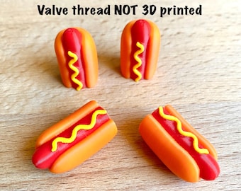 May include: Four hot dog shaped valve caps with red sausages, orange buns, and yellow mustard details. The text above reads: Built-in high-quality valve! Valve thread NOT 3D printed. These small items feature a realistic food design.