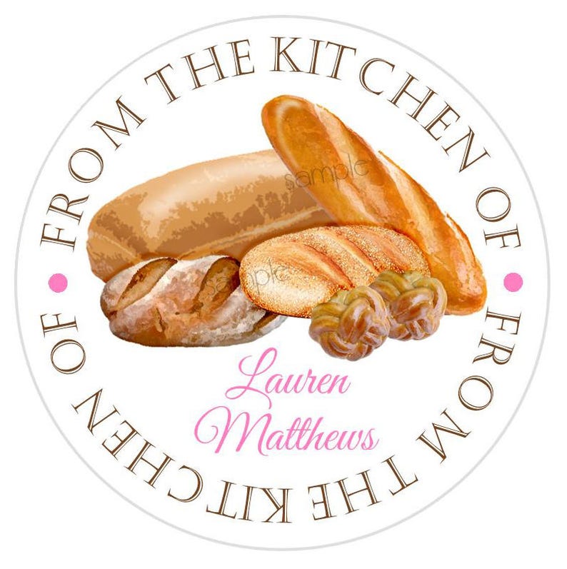 May include: Round white sticker with brown text that reads "From the Kitchen of" and "From the Kitchen of" in a circle. The sticker features a variety of breads, including a loaf of bread, a baguette, and a braided bread. The text "Lauren Matthews" is written in pink cursive.