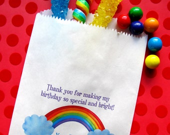 May include: White paper bag with a rainbow and clouds design. The bag has the text "Thank you for making my birthday so special and bright!" and "Your Friend, Francesca". The bag is filled with colorful candy, including rock candy and gumballs. The bag is on a red background with white polka dots. The text "LITTLEbeane BOUTIQUE" is at the bottom of the image.