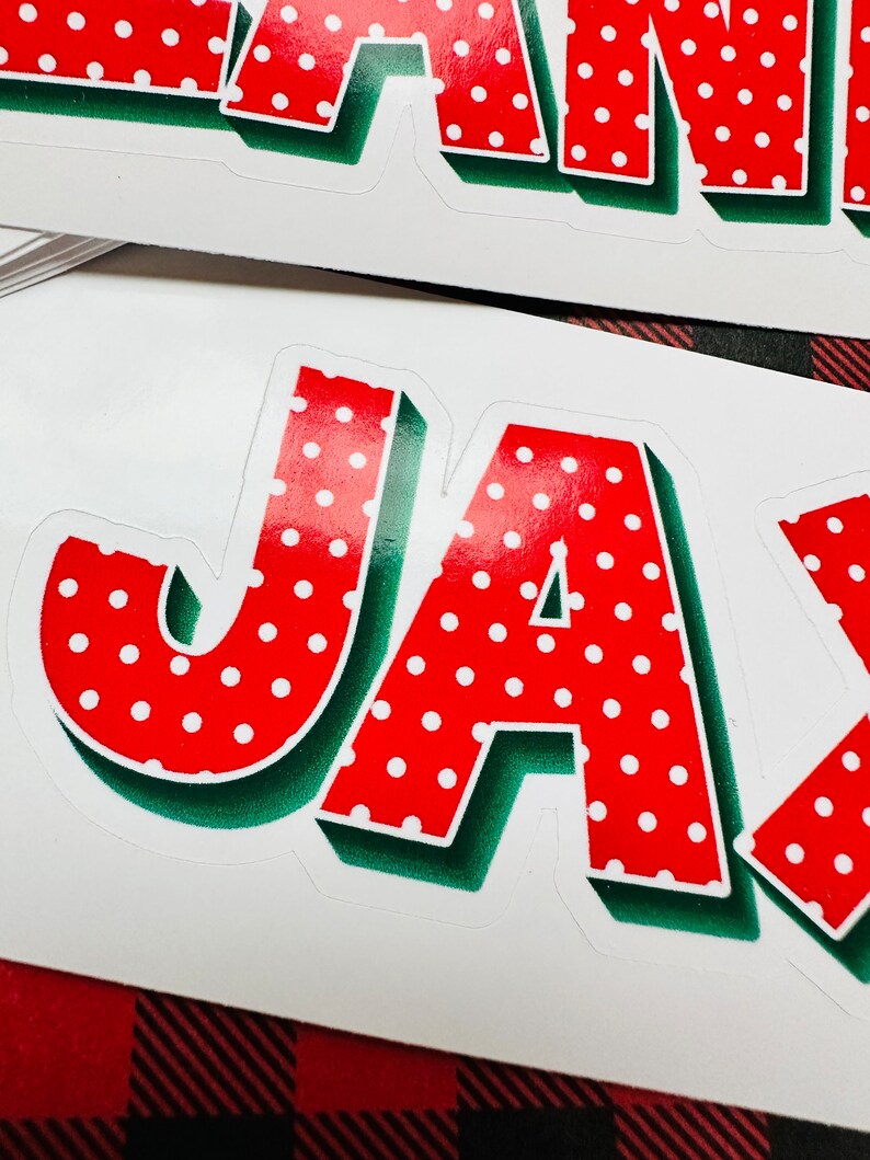 May include: Red and white polka dot letters spelling out the name "JAY" with a green outline. The letters are in a 3D style.
