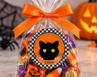May include: A clear plastic treat bag filled with assorted sweets, tied with an orange satin ribbon. A circular label features a black cat silhouette with yellow eyes, a black and white buffalo check border, and the text WISHING YOU TRICKS & TREATS! EMMA.