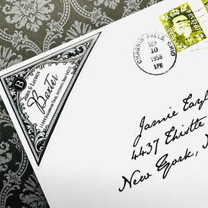 May include: A white envelope with a black and white decorative return address label for John & Lauren Baxter. The envelope is postmarked from Chagrin Falls, Ohio, September 10, 1958, and addressed to Jamie Eaz in New York.