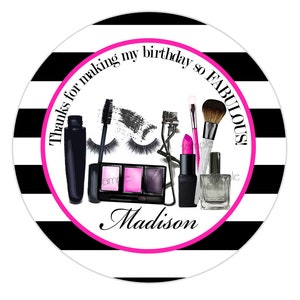 May include: Black and white striped circle with the text "Thanks for making my birthday so FABULOUS!" in pink.  The center of the circle features a variety of makeup items, including mascara, eyeliner, eyeshadow, lipstick, and a makeup brush. The name "Madison" is written in pink at the bottom of the circle.