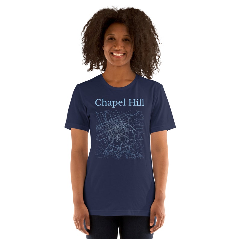 May include: A navy blue t-shirt with a light blue outline of a city map and the text "Chapel Hill" printed on the front.