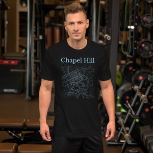 May include: Black t-shirt with a blue outline map of Chapel Hill, North Carolina.