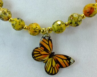 Enameled Metal Orange and Black Butterfly Pendant on a Necklace of Yellow Speckled Jasper Stone Beads Beads