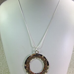 Large Metal Donut Pendant Enscribed with a Flowing Design and Tiny Crystal Embellishments on a Chain image 2