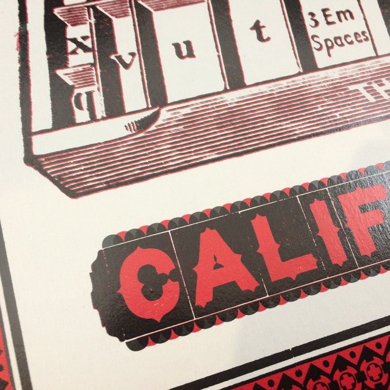 May include: A red and black vintage poster with the word "CALIF" in large red letters on a black background. The poster has a black and white illustration of a building with the words "3 Em Spaces" at the top.