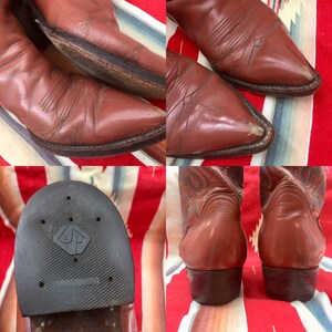 May include: A pair of brown leather cowboy boots with a pointed toe and a decorative stitch pattern. The boots have a rubber sole with a diamond-shaped logo.
