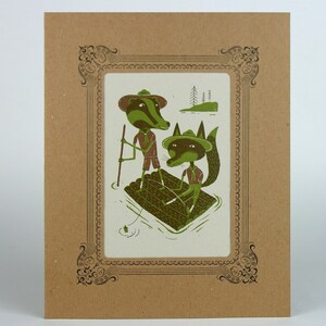 May include: A brown and green illustration of two animals wearing scout hats and uniforms, floating on a log in a lake. The animals are a badger and a fox. The illustration is framed in a brown ornate frame.