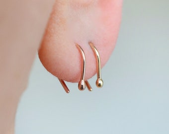 Solid 14K rose or yellow gold arc ear hugger with tiny ball for minimalist men or women