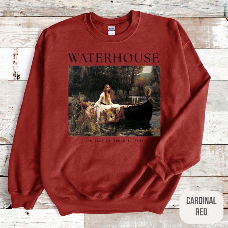 May include: Red sweatshirt with a painting of a woman in a boat on the front. The painting is titled "The Lady of Shalott, 1888" and the artist's name, "WATERHOUSE", is printed above the painting.
