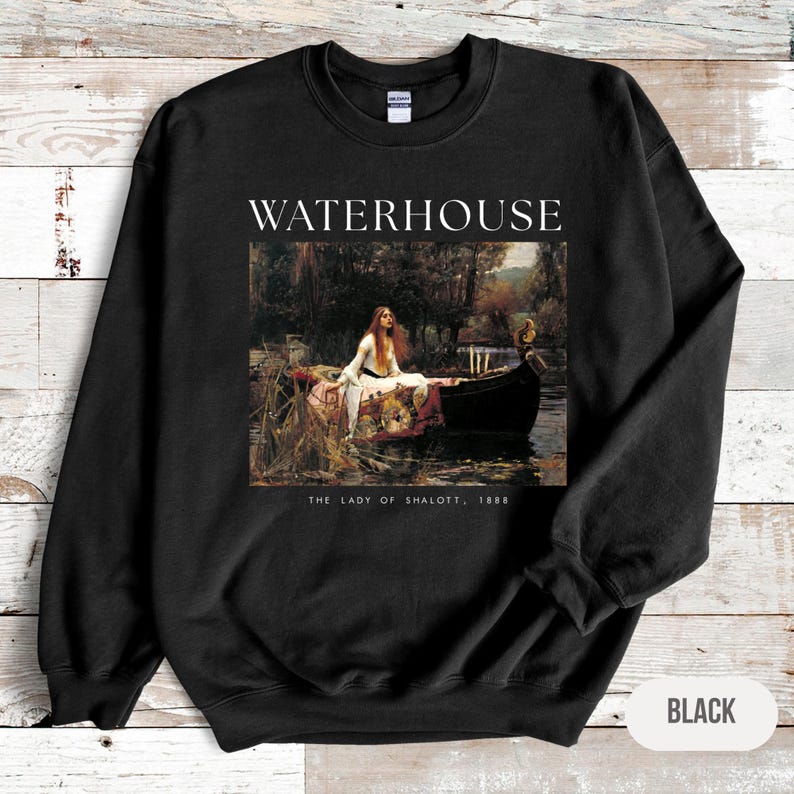 May include: Black sweatshirt with a graphic print of a painting titled "The Lady of Shalott, 1888" by John William Waterhouse. The painting depicts a woman in a boat on a river.