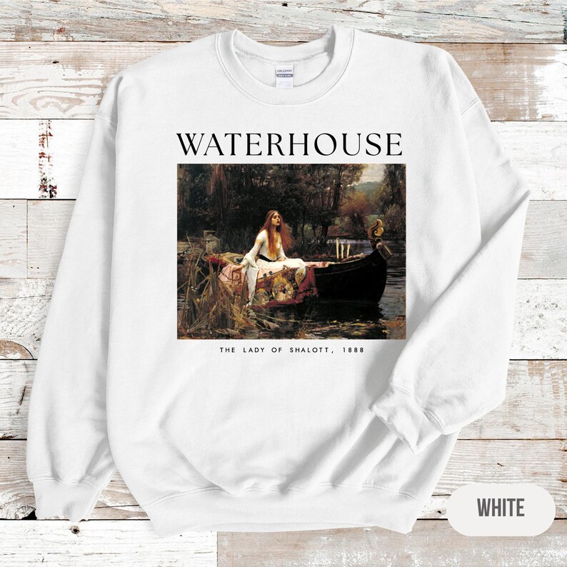 May include: White sweatshirt with a print of a painting by John William Waterhouse titled "The Lady of Shalott, 1888". The painting depicts a woman in a boat on a river.