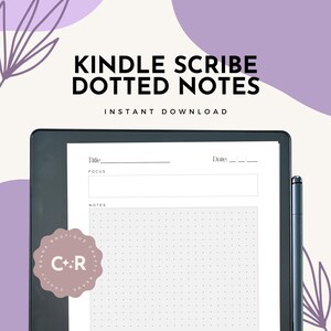 May include: A Kindle Scribe e-reader with a dotted note template displayed on the screen. The screen shows a title, focus, and notes section with a dotted grid. The e-reader is black and has a stylus next to it.