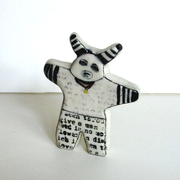 small porcelain figure with underglaze drawing and overglaze decals