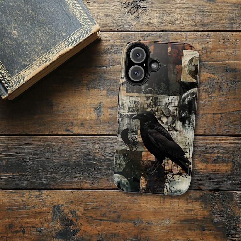 May include: A black phone case with a collage design featuring a raven, vintage paper, and a moon. The case has a black camera lens cutout.