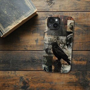 May include: A black phone case with a collage design featuring a raven, moons, and vintage-looking paper. The case has a black camera bump with three lenses.