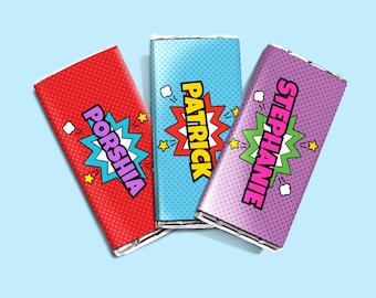 May include: Three candy bars with comic book-style wrappers. The wrappers are red, blue, and purple, each with a different name in a bold font: Porshia, Patrick, and Stephanie. Each wrapper has a starburst graphic.