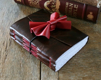 Leather Journal . "Bowties are cool!" Journal (Doctor Who inspired) . dark brown leather with red bowtie. handmade handbound (320 pgs)