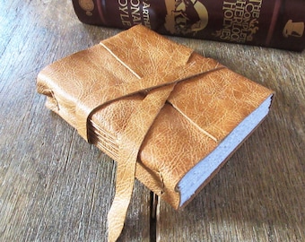 Leather Journal - Emily Dickinson quote: "We grow not older with years, but newer every day". pebble-grain butter tan. handbound (320 pgs)
