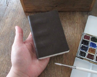 Watercolor Leather Sketchbook Pocket Tome 4.5” x 3” portrait. dark moss / greyish green leather . Canson XL multi-media watercolour paper