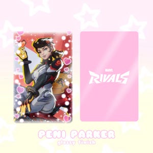 May include: A glossy card featuring Peni Parker from Marvel Rivals. The front displays a character illustration with a red, white, and black color scheme, surrounded by hearts. The back is pink with the Marvel Rivals logo.